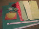 Beginning Supplies: 2 Sheets of patterned paper, an array of paper scraps cut into strips, a journal spot, flowers, lace, and gems